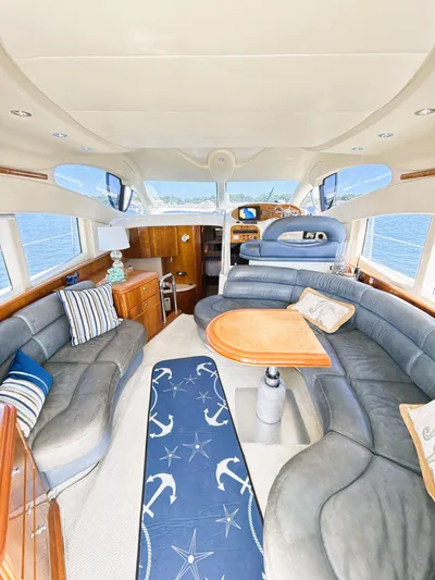 Four Shore Yacht Photos Pics Luxurious interior of a 2002 Azimut 42 yacht with elegant seating and nautical decor.