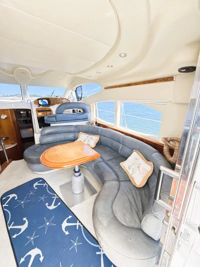 Four Shore Yacht Photos Pics Luxurious interior of a 2002 Azimut 42 yacht with elegant seating and nautical decor.