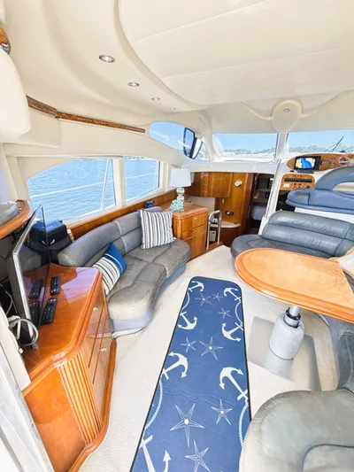 Four Shore Yacht Photos Pics Luxurious interior of a 2002 Azimut 42 yacht with elegant seating and nautical decor.