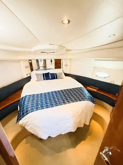 Four Shore Yacht Photos Pics Luxurious bedroom interior of a 2002 Azimut 42 yacht with elegant bedding and modern design.