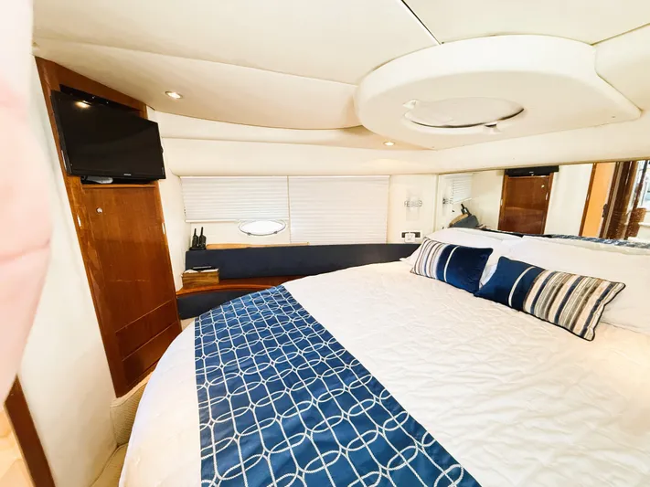 Four Shore Yacht Photos Pics Luxurious bedroom interior of a 2002 Azimut 42 yacht with elegant bedding and modern amenities.