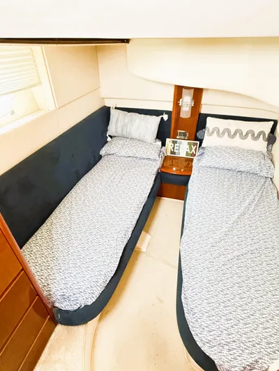 Four Shore Yacht Photos Pics Twin beds in a 2002 Azimut 42 yacht cabin with cozy bedding.