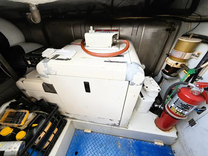 Four Shore Yacht Photos Pics Engine room of a 2002 Azimut 42 yacht with equipment and fire extinguisher.