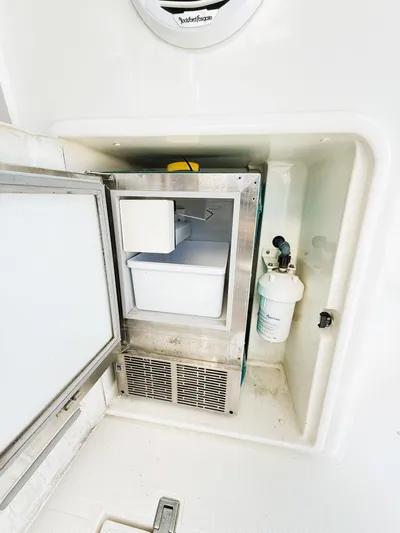Four Shore Yacht Photos Pics Built-in ice maker on a 2002 Azimut 42 yacht, featuring a compact design.
