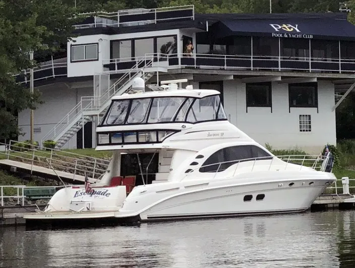 Escapade Too Yacht Photos Pics 2007 Sea Ray 58 Sedan Bridge yacht docked at a marina near a yacht club.