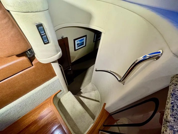 Escapade Too Yacht Photos Pics Staircase inside 2007 Sea Ray 58 Sedan Bridge yacht with elegant design and wooden flooring.