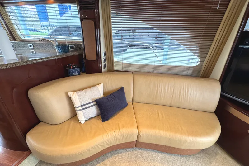 Escapade Too Yacht Photos Pics Luxurious interior of 2007 Sea Ray 58 Sedan Bridge with beige leather sofa.