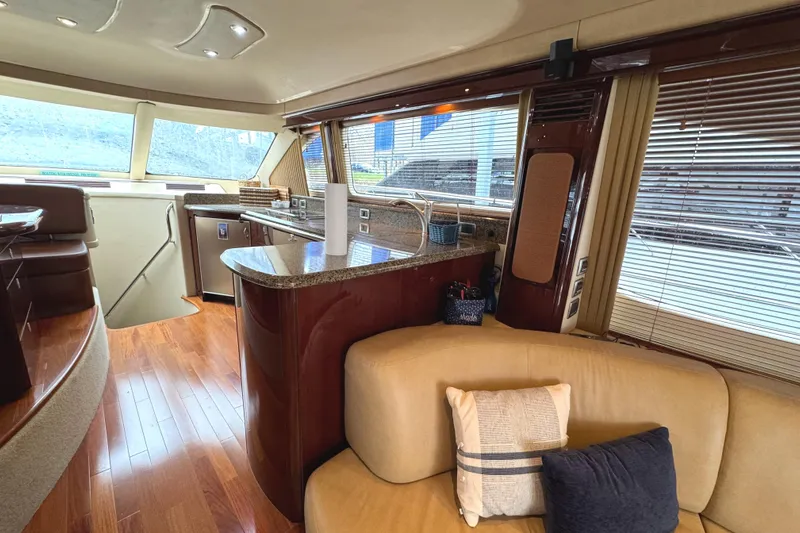 Escapade Too Yacht Photos Pics Luxurious interior of 2007 Sea Ray 58 Sedan Bridge yacht with modern kitchen and seating area.