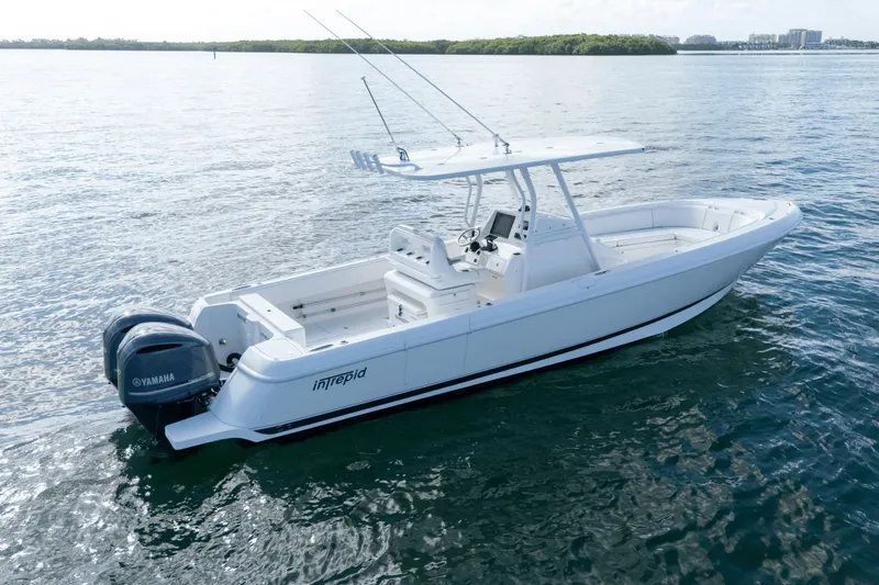 Yacht Photos Pics 2015 Intrepid 327 CC INFUSED boat on calm water, featuring Yamaha engines.