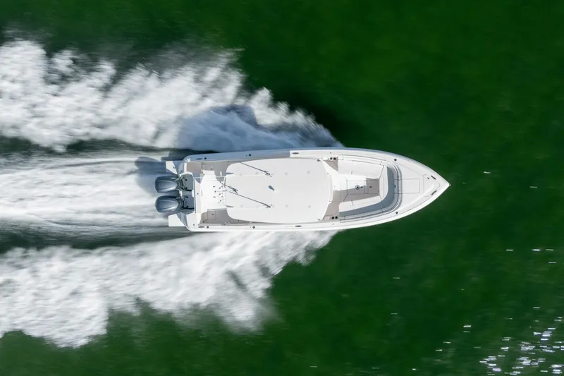  Yacht Photos Pics Aerial view of 2015 Intrepid 327 CC INFUSED boat speeding on water.