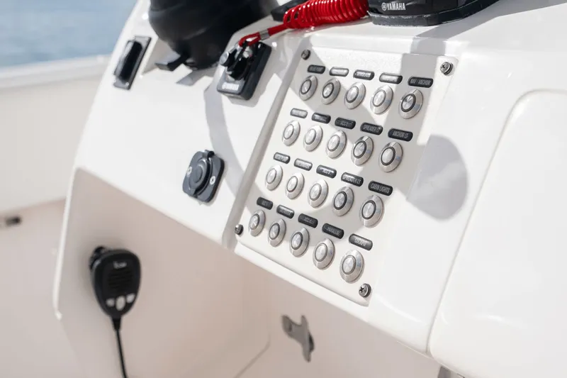  Yacht Photos Pics Control panel of a 2015 Intrepid 327 CC INFUSED boat with various buttons and switches.