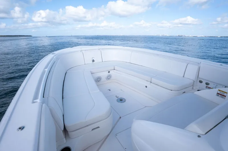  Yacht Photos Pics 2015 Intrepid 327 CC boat with white seating, ocean view, and blue sky.
