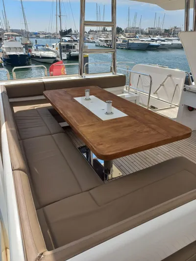  Yacht Photos Pics Luxury yacht Fairline Squadron 78, 2017, with elegant outdoor seating and wooden table.