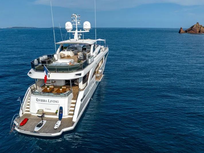 Riviera Living Yacht Photos Pics Luxurious 2017 Princess 35M yacht cruising in open sea near rocky island.