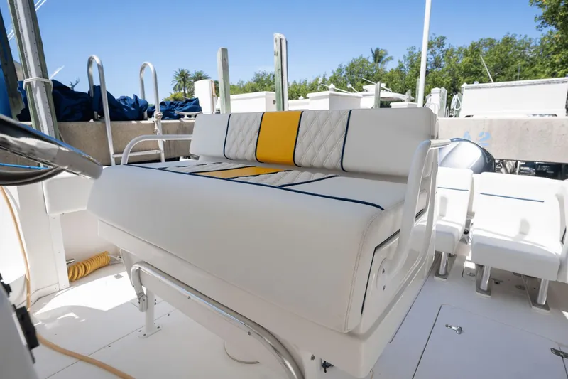  Yacht Photos Pics 2005 Intrepid 348 WA boat interior with white and yellow seating, sunny day.