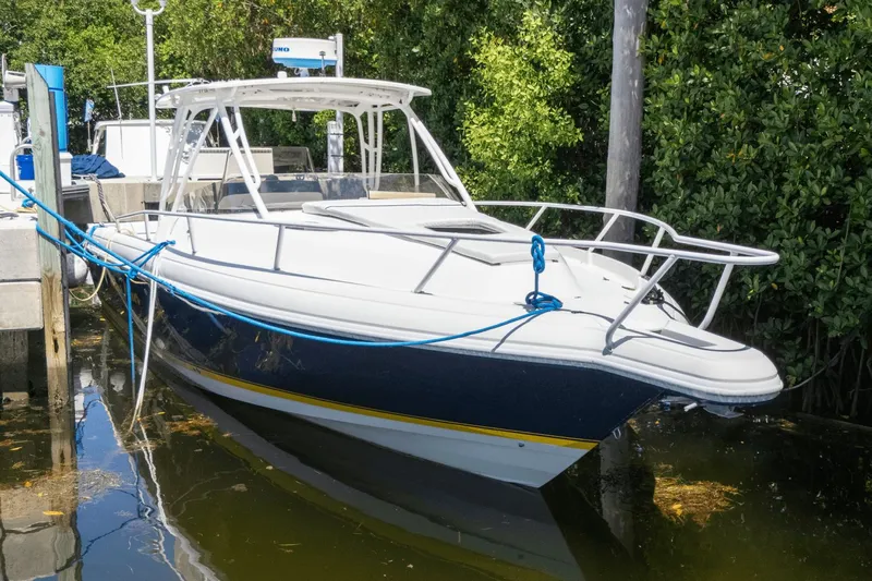  Yacht Photos Pics 2005 Intrepid 348 WA boat docked, featuring sleek design and white-blue color scheme.