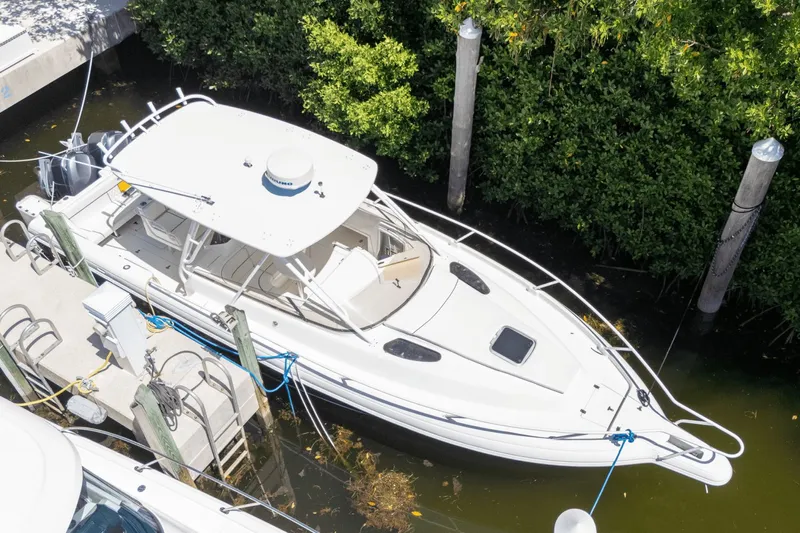  Yacht Photos Pics 2005 Intrepid 348 WA boat docked near lush greenery.