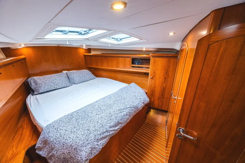  Yacht Photos Pics Luxurious cabin interior of 2006 Jeanneau Sun Odyssey 49 yacht with wooden finish.