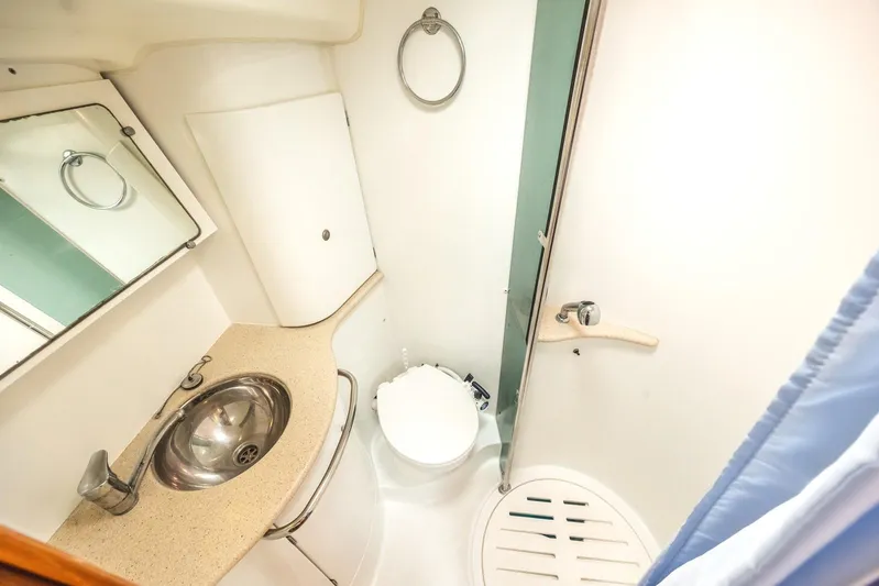  Yacht Photos Pics Compact bathroom in 2006 Jeanneau Sun Odyssey 49 yacht with sink, toilet, and shower.