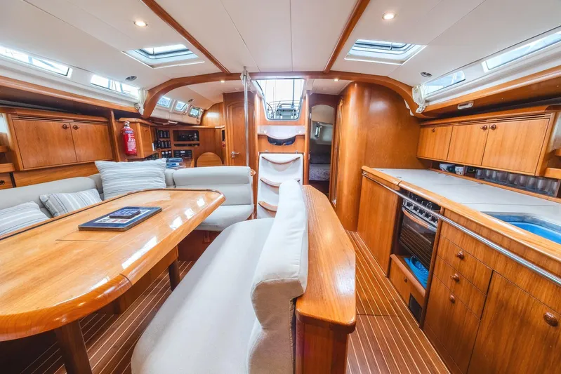  Yacht Photos Pics Interior of 2006 Jeanneau Sun Odyssey 49 yacht with wooden furnishings and modern amenities.