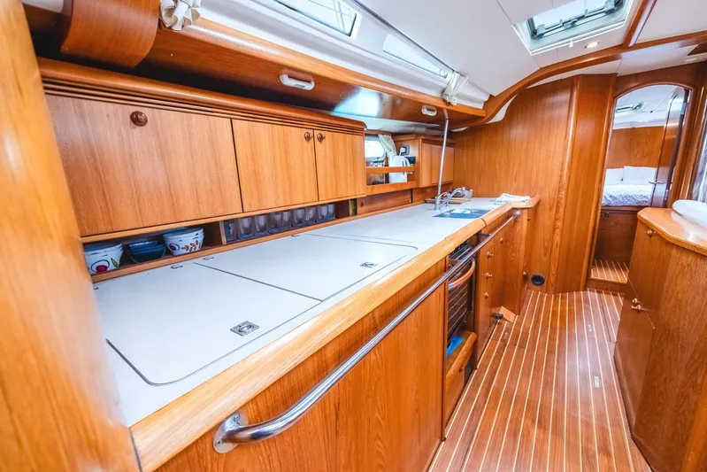  Yacht Photos Pics Interior of 2006 Jeanneau Sun Odyssey 49 yacht with wooden cabinetry and sleek design.