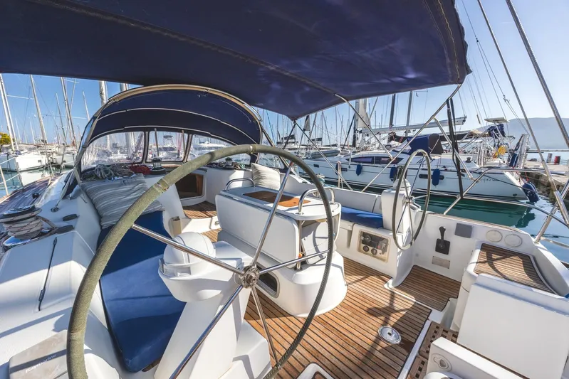  Yacht Photos Pics 2006 Jeanneau Sun Odyssey 49 sailboat with dual steering wheels in a marina.