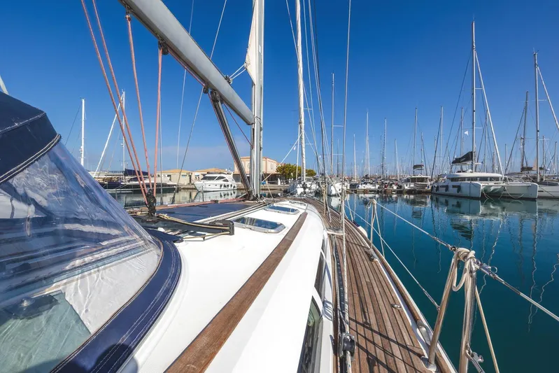  Yacht Photos Pics 2006 Jeanneau Sun Odyssey 49 sailboat docked in a marina under clear blue skies.