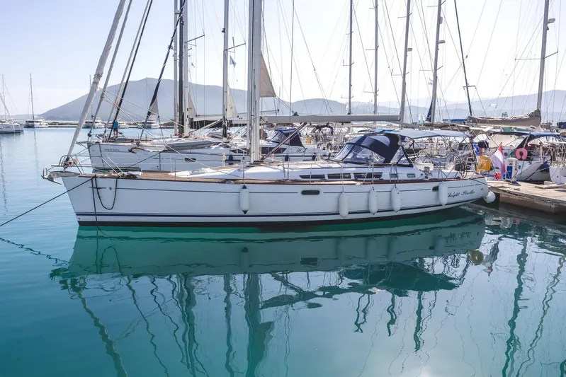  Yacht Photos Pics Jeanneau Sun Odyssey 49 sailboat, 2006 model, docked in a serene marina setting.