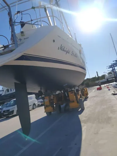  Yacht Photos Pics 2006 Jeanneau Sun Odyssey 49 sailboat on land under bright sunlight.