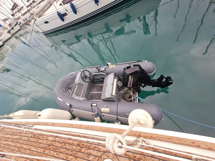  Yacht Photos Pics Inflatable dinghy with outboard motor docked beside Jeanneau Sun Odyssey 49, 2006 model.
