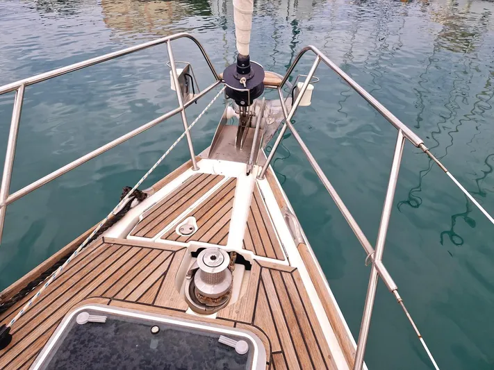  Yacht Photos Pics Bow of 2006 Jeanneau Sun Odyssey 49 sailboat with teak decking and stainless steel railings.