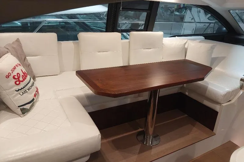 Grata Yacht Photos Pics Luxurious interior of 2022 Fairline Targa 45 GT yacht with white seating and wooden table.