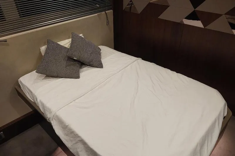 Grata Yacht Photos Pics Interior cabin of 2022 Fairline Targa 45 GT yacht with bed and pillows.