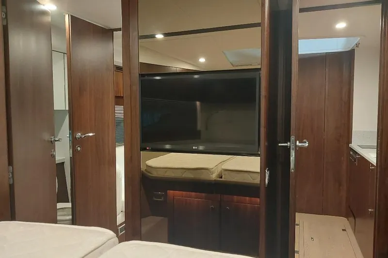 Grata Yacht Photos Pics Interior of 2022 Fairline Targa 45 GT yacht with modern wood finish and TV.