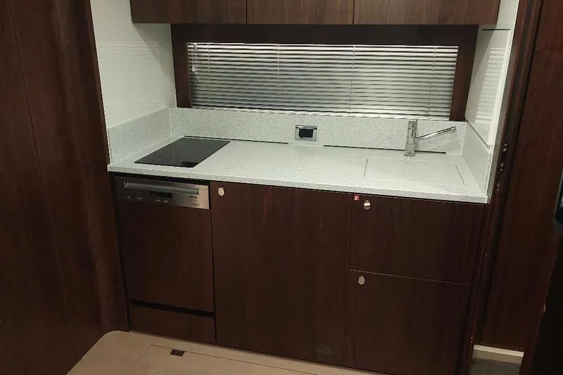 Grata Yacht Photos Pics Modern kitchen in 2022 Fairline Targa 45 GT yacht with sleek dark wood cabinetry.