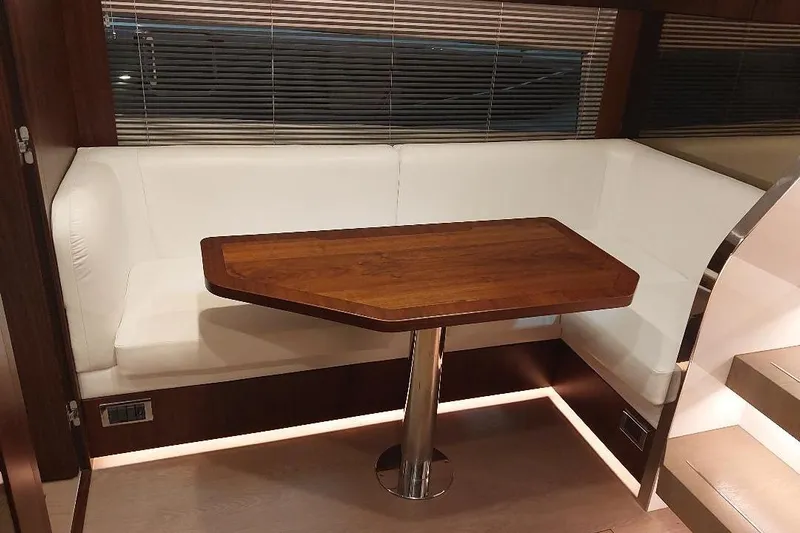 Grata Yacht Photos Pics Luxurious interior of 2022 Fairline Targa 45 GT with elegant wood table and white seating.