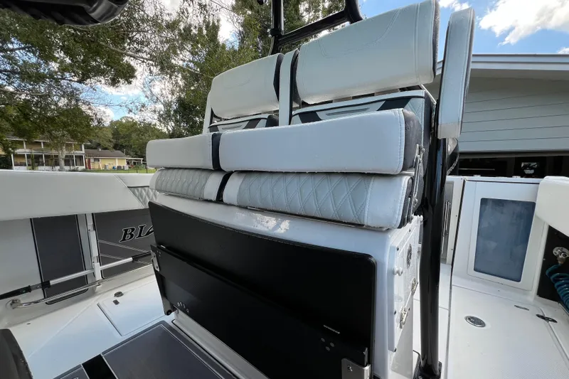  Yacht Photos Pics 2023 Blackfin 272 boat interior with cushioned seating and sleek design.