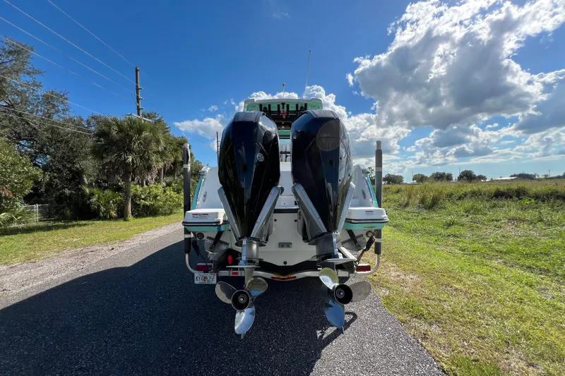  Yacht Photos Pics 2023 Blackfin 272 boat with dual outboard motors on a sunny day.