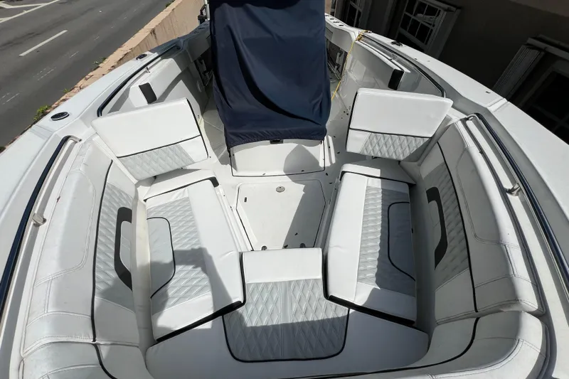  Yacht Photos Pics 2023 Blackfin 272 boat interior with white cushioned seating and covered console.
