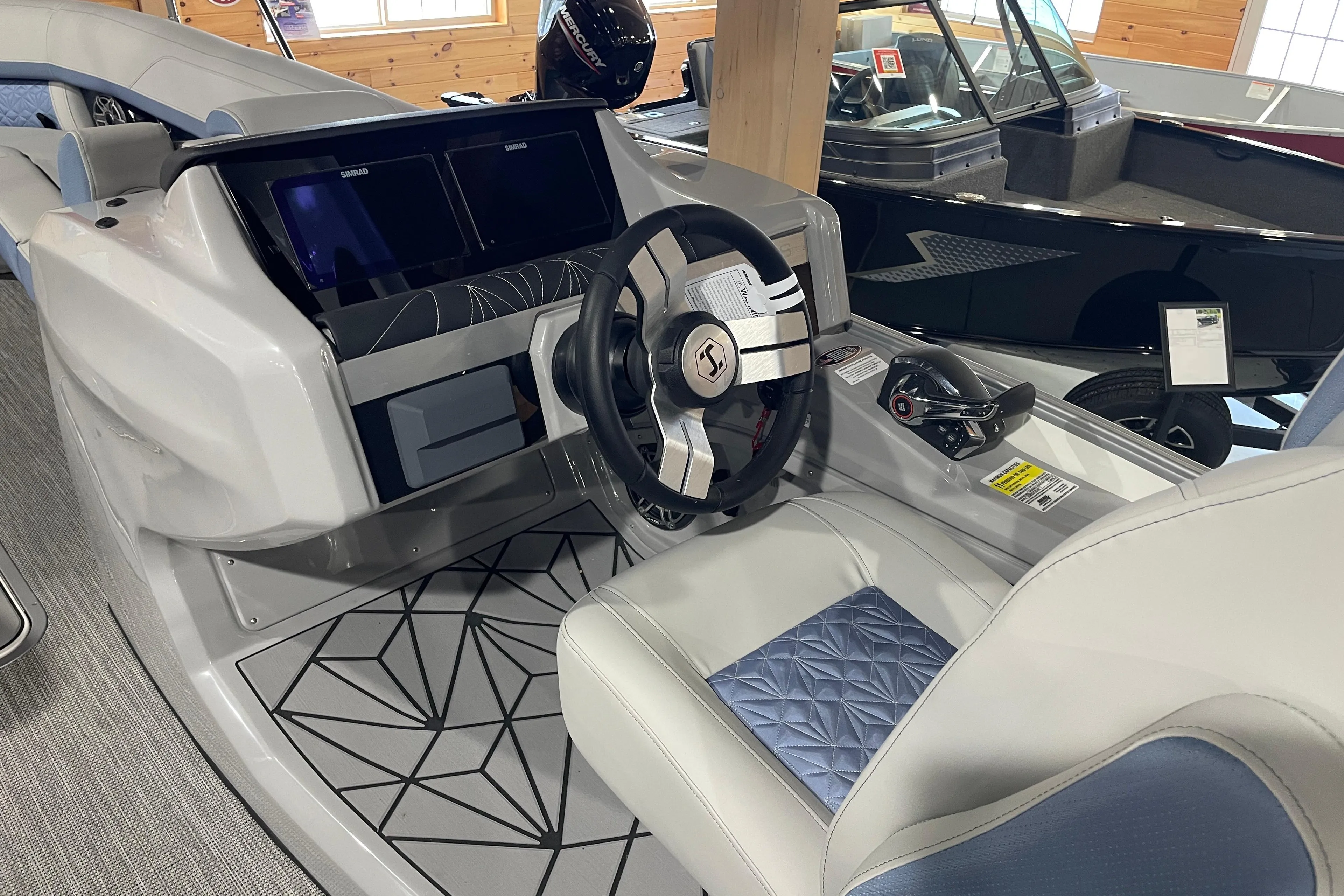 2026 Harris Grand Mariner SEL 250 boat interior with modern steering and dual screens.