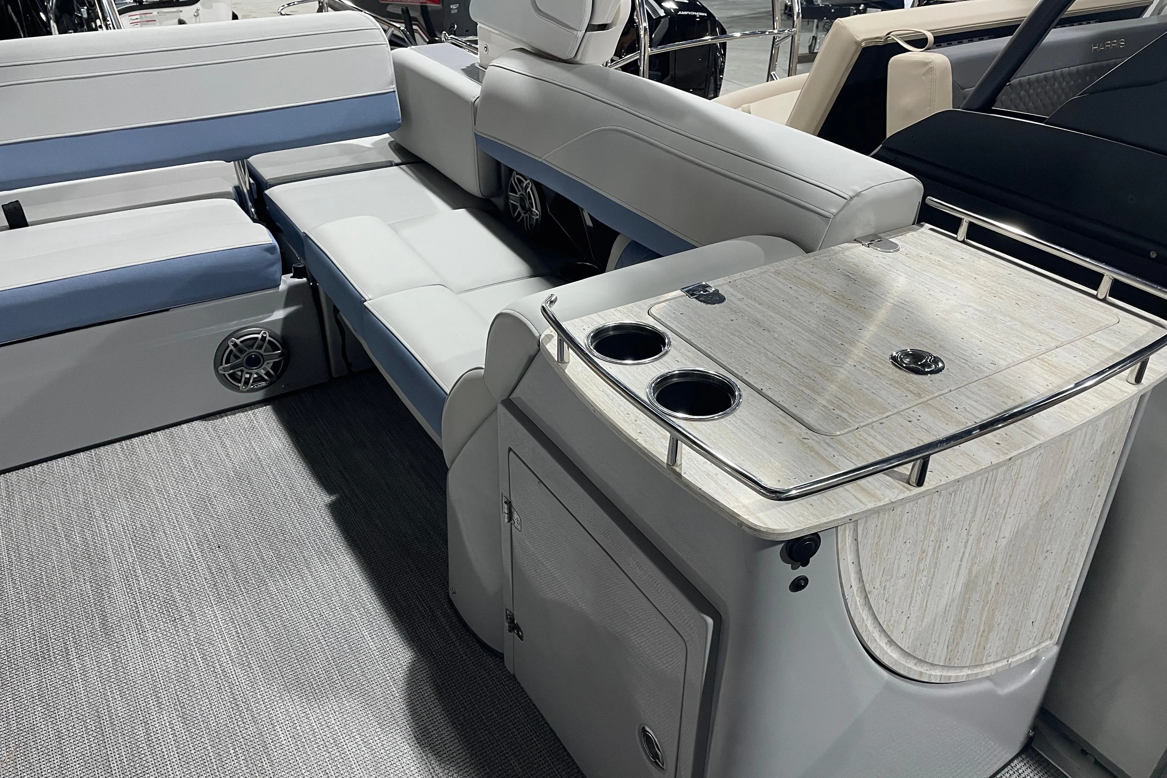 2026 Harris Grand Mariner SEL 250 interior with seating and table, showcasing luxury design.