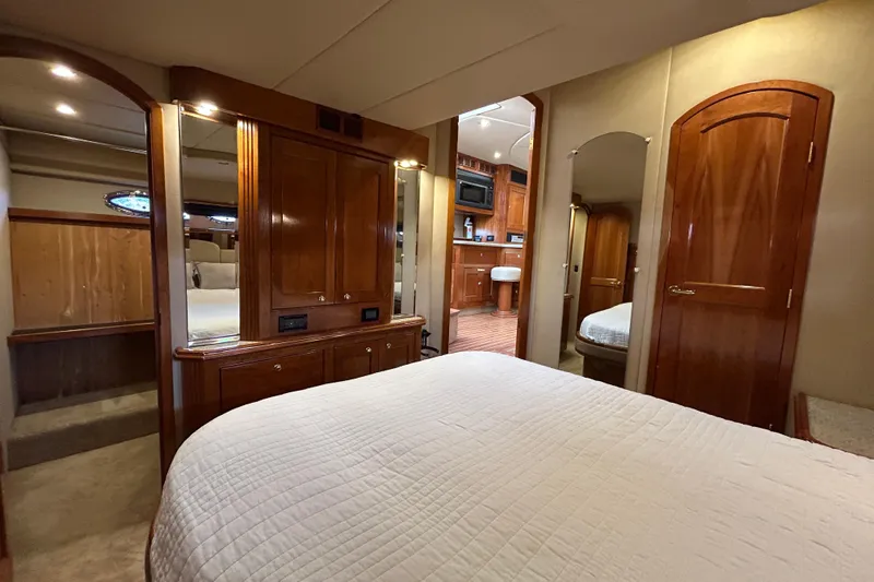  Yacht Photos Pics Luxurious 2003 Cruisers Yachts 540 Express interior with elegant wood finishes and cozy bedroom.
