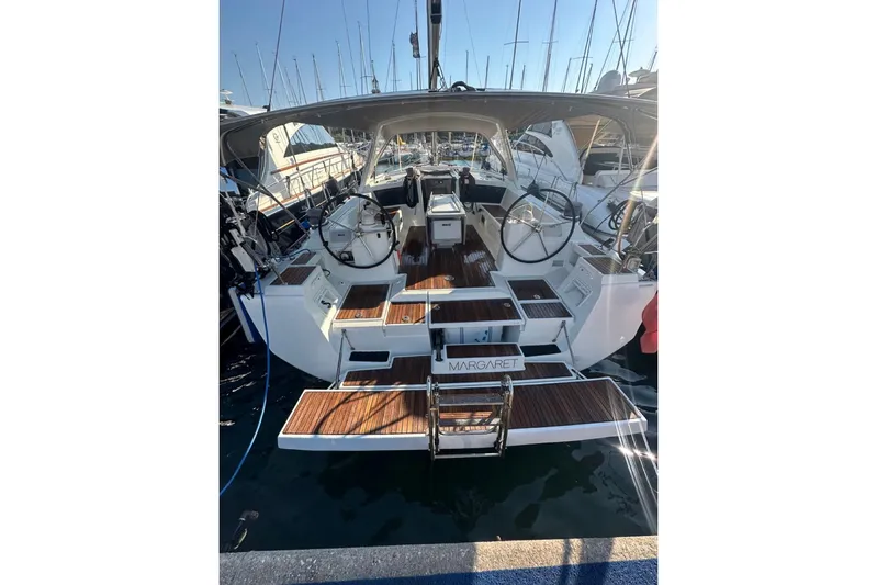 Margaret Yacht Photos Pics 2014 Beneteau Oceanis 48 yacht with dual steering wheels, docked in a marina.