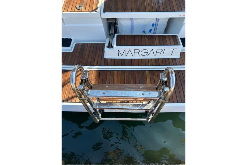 Margaret Yacht Photos Pics Stern view of 2014 Beneteau Oceanis 48 yacht with wooden deck and ladder.