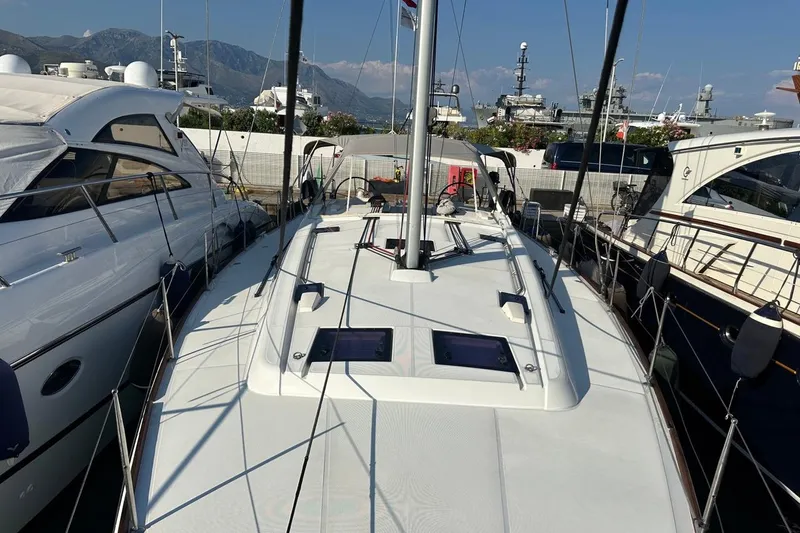 Margaret Yacht Photos Pics 2014 Beneteau Oceanis 48 sailboat docked, surrounded by other yachts, with mountainous backdrop.