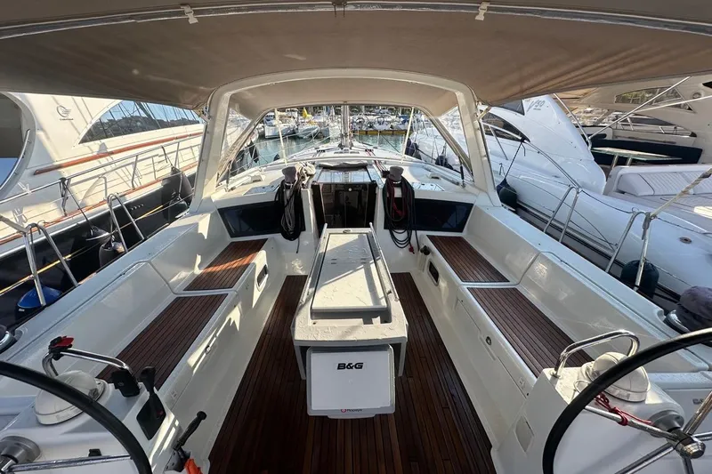 Margaret Yacht Photos Pics 2014 Beneteau Oceanis 48 yacht cockpit with wooden seating and steering wheel.