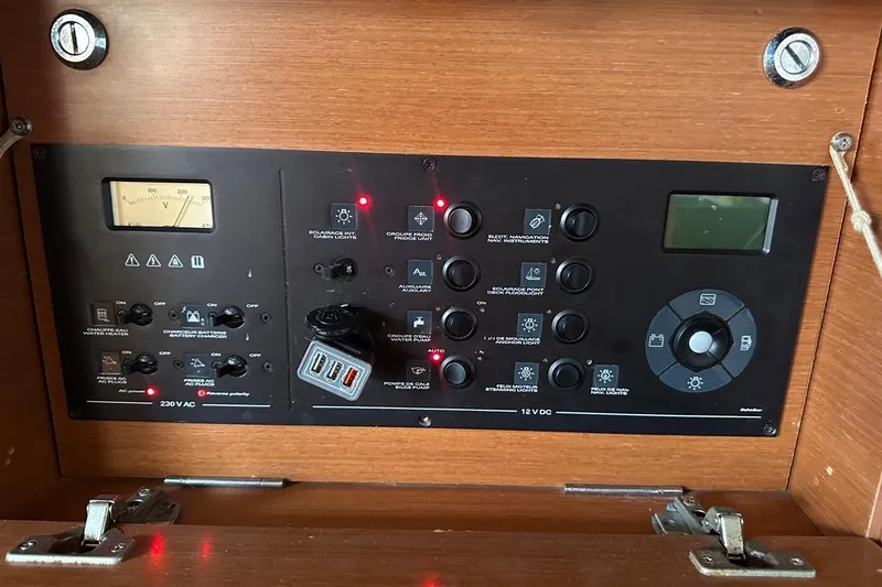 Margaret Yacht Photos Pics Control panel of a 2014 Beneteau Oceanis 48 sailboat with various switches and indicators.