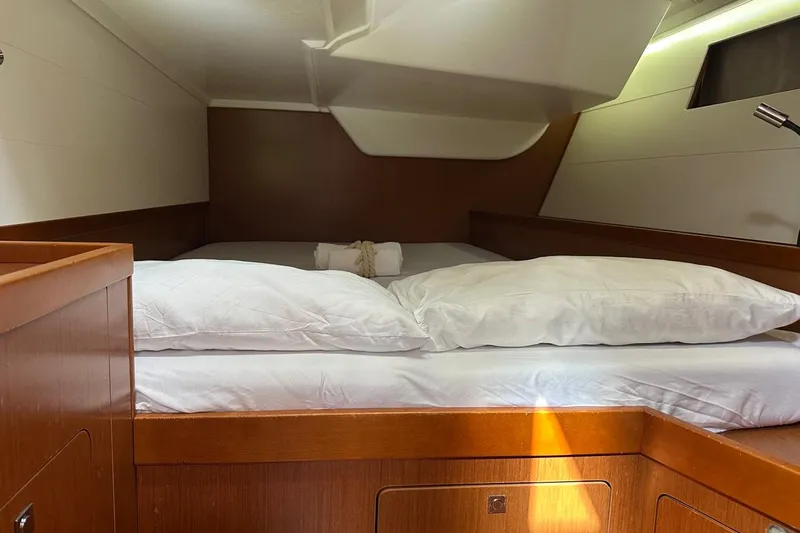 Margaret Yacht Photos Pics Cozy cabin interior of 2014 Beneteau Oceanis 48 yacht with neatly arranged bedding.