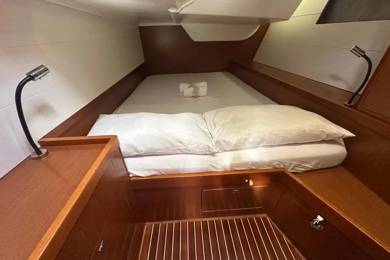 Margaret Yacht Photos Pics Cozy cabin interior of 2014 Beneteau Oceanis 48 yacht with wooden finish and reading lights.