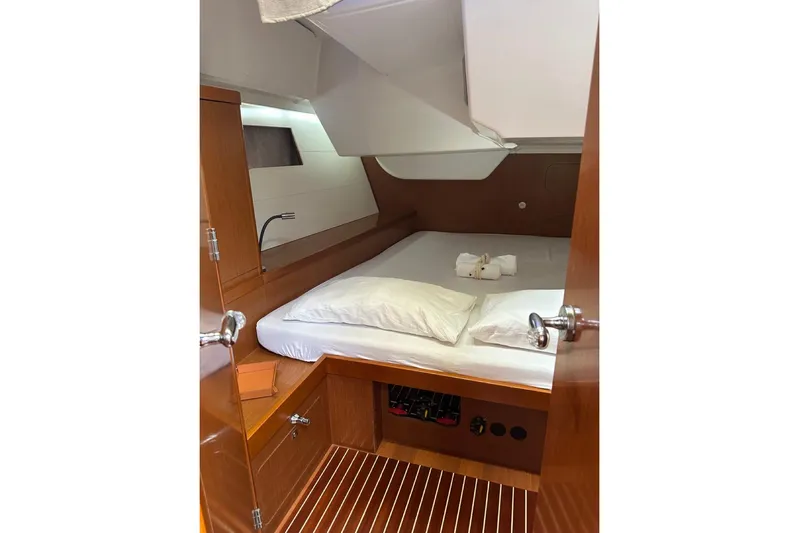 Margaret Yacht Photos Pics Cozy cabin interior of 2014 Beneteau Oceanis 48 yacht with wooden finish and comfortable bedding.